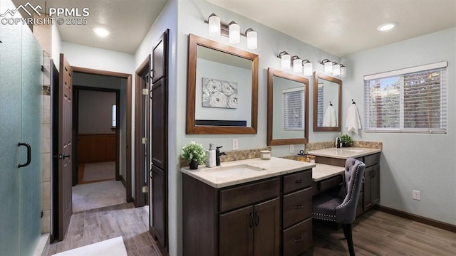 bathroom with vanity, hardwood / wood-style flooring, and an enclosed shower