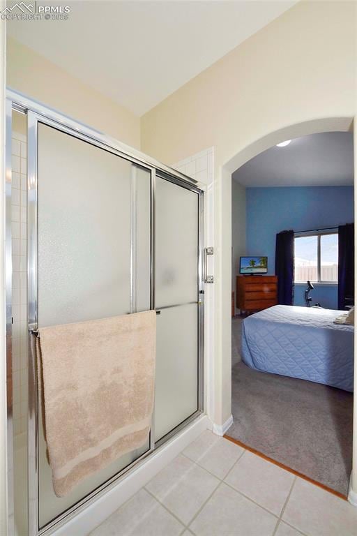 bathroom featuring tile patterned floors and a shower with door