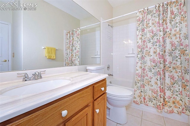 bathroom with toilet, vanity, and tile patterned floors