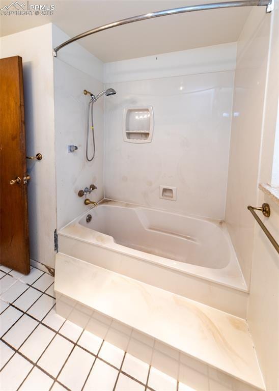 bathroom with tile patterned floors and bathtub / shower combination