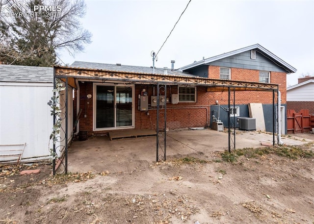 rear view of house featuring central AC unit