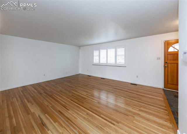 unfurnished room featuring light wood-type flooring