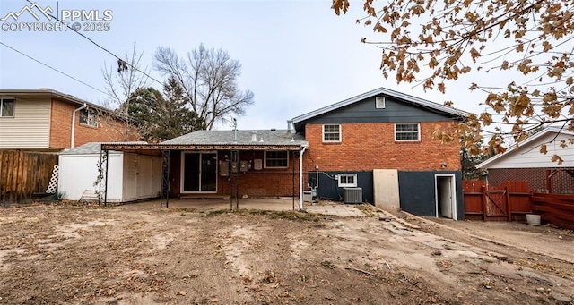 rear view of property with central air condition unit and a patio