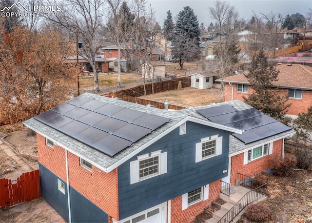 exterior space with solar panels and a shed