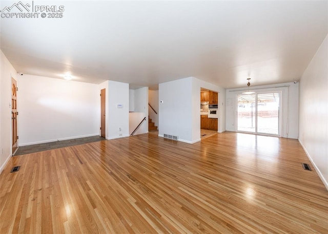 unfurnished living room featuring light hardwood / wood-style flooring