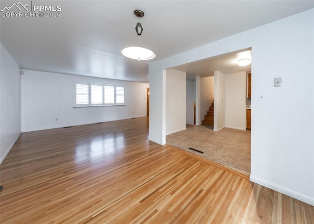 unfurnished room with wood-type flooring