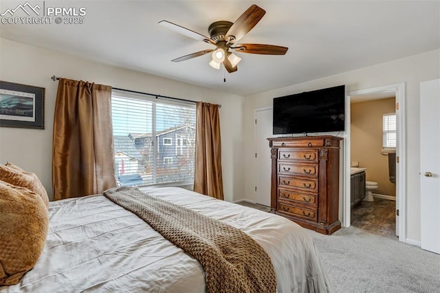 carpeted bedroom featuring ceiling fan and ensuite bathroom