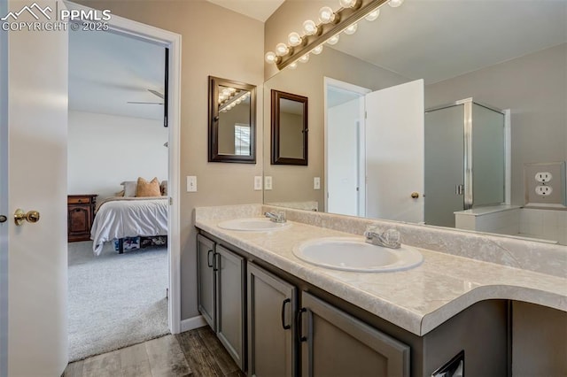 bathroom with vanity, ceiling fan, an enclosed shower, and wood-type flooring