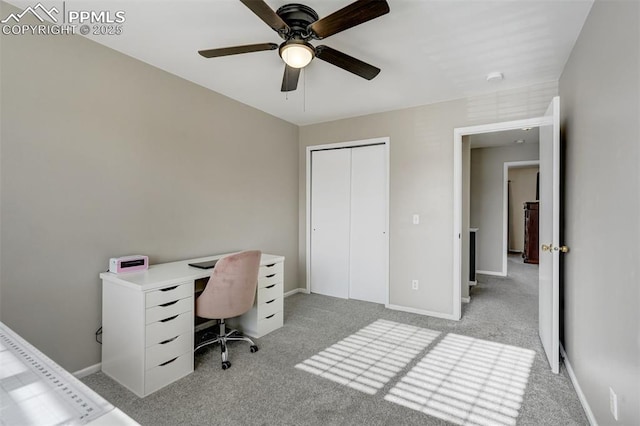 office space featuring ceiling fan and light colored carpet