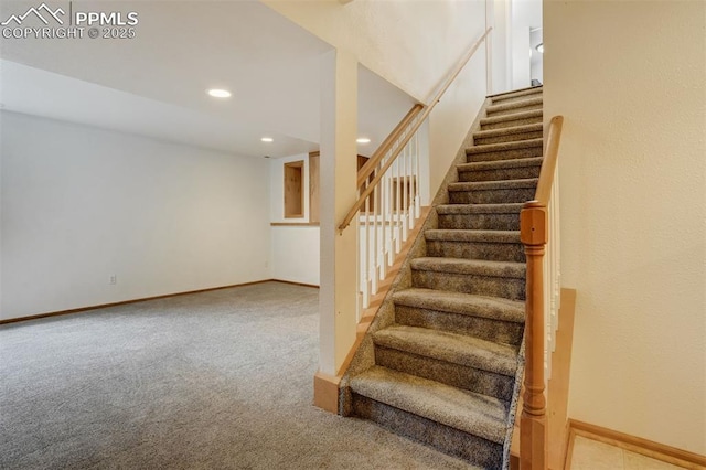 stairs featuring carpet flooring