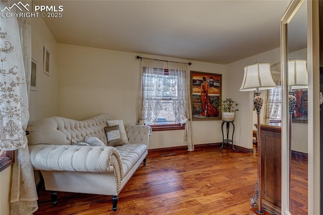 sitting room with hardwood / wood-style flooring