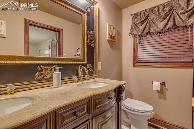 bathroom with vanity and toilet