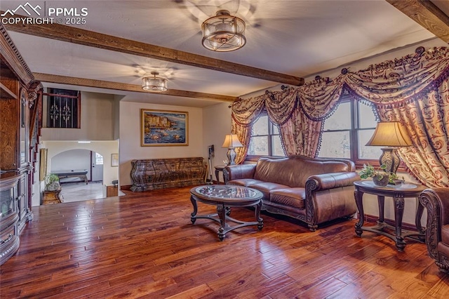 living room featuring beamed ceiling and hardwood / wood-style flooring