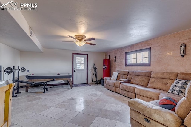 living room with plenty of natural light and ceiling fan