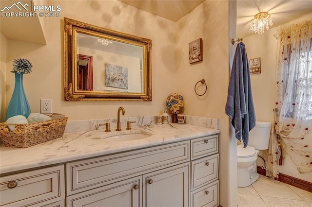 bathroom with tile patterned flooring, vanity, and toilet