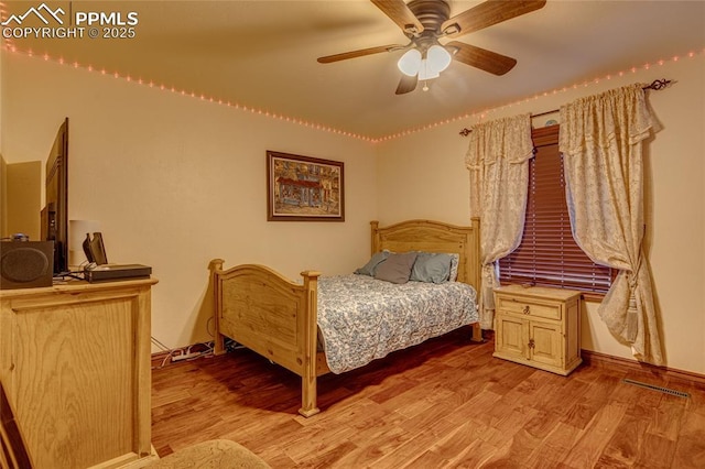 bedroom with ceiling fan and light hardwood / wood-style flooring