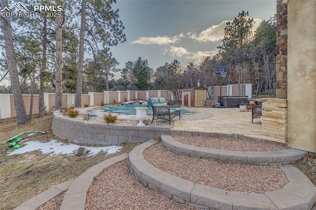 view of pool featuring a jacuzzi and a patio