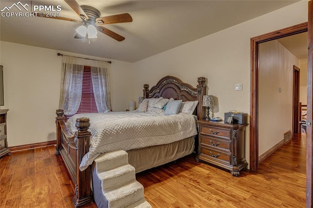 bedroom with ceiling fan and light hardwood / wood-style floors