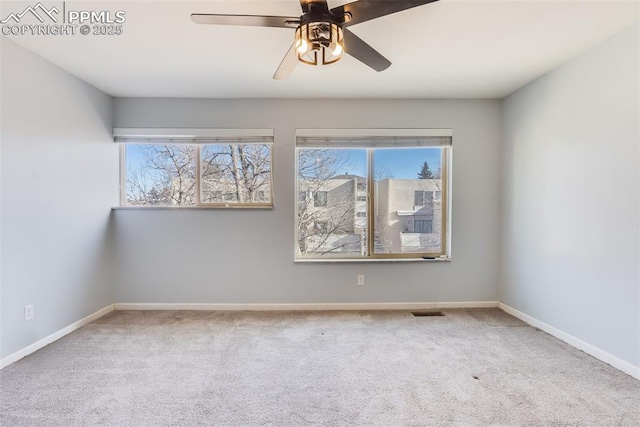 carpeted empty room featuring ceiling fan