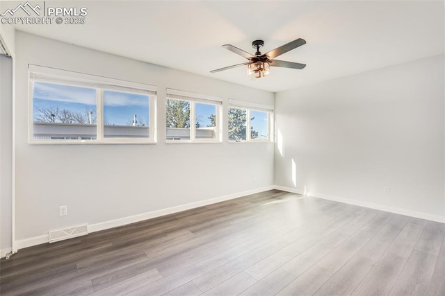 unfurnished room with ceiling fan and hardwood / wood-style floors