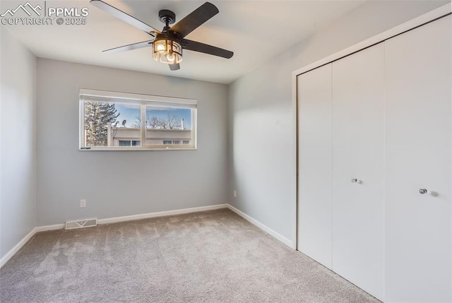 unfurnished bedroom featuring ceiling fan, carpet floors, and a closet