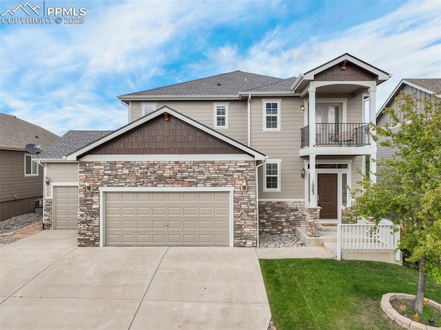 craftsman house featuring a garage, a balcony, and a front lawn