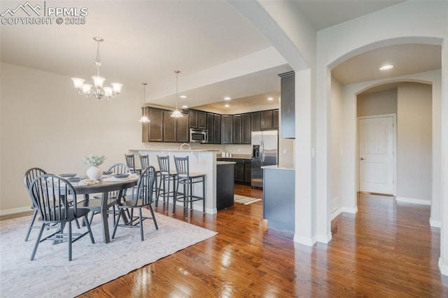 dining room with a notable chandelier and dark hardwood / wood-style floors