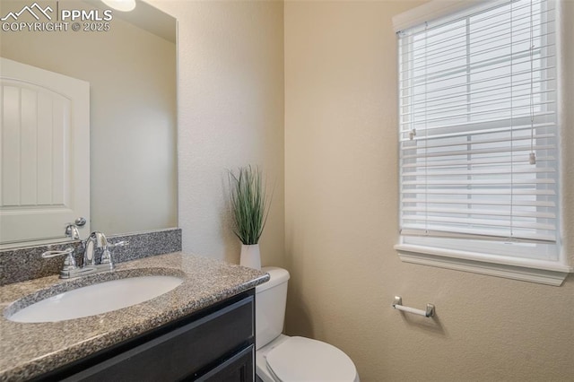 bathroom featuring vanity and toilet