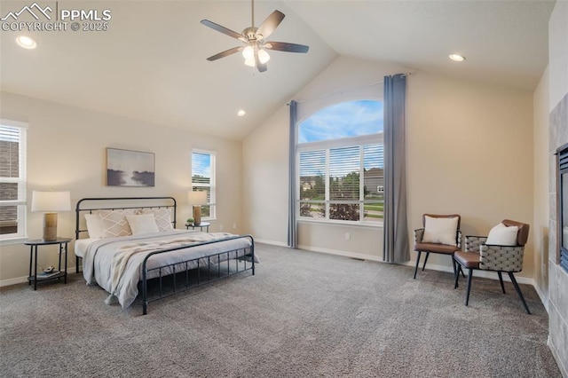 carpeted bedroom with ceiling fan and vaulted ceiling