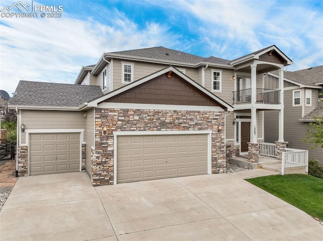 craftsman house with a balcony, a porch, and a garage