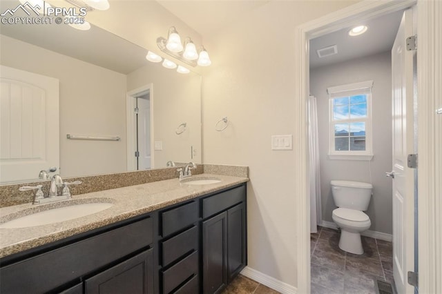 bathroom featuring vanity and toilet