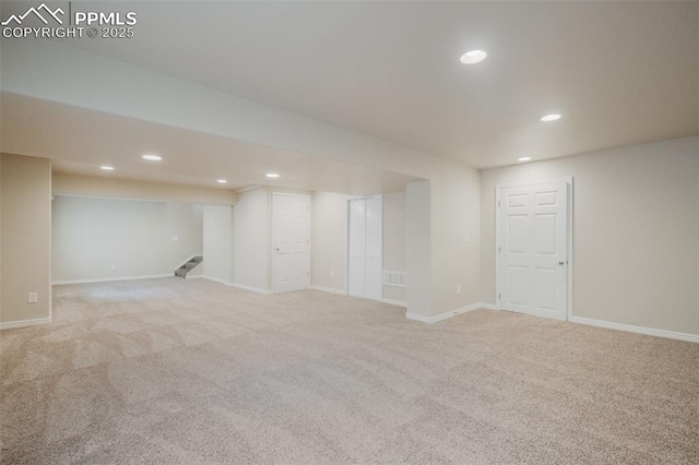 basement featuring light colored carpet