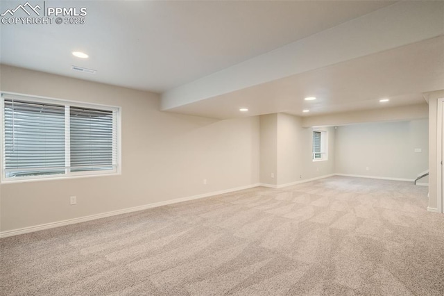 basement featuring light colored carpet