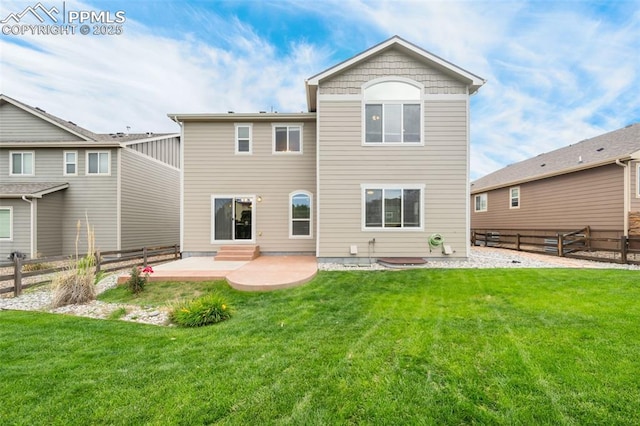 back of house with a lawn and a patio area