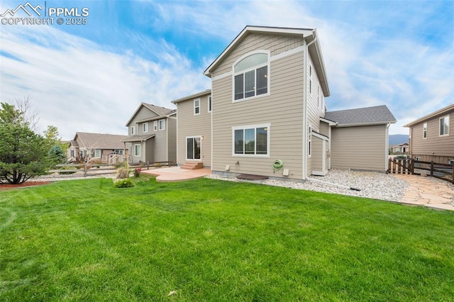 back of house featuring a patio area and a lawn