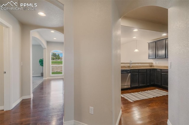 corridor featuring dark hardwood / wood-style flooring and sink