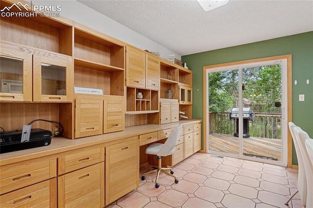 office area with built in desk and a textured ceiling