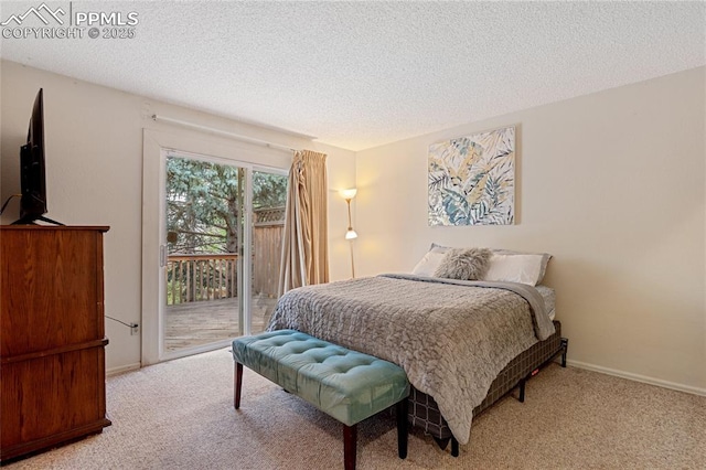 bedroom featuring access to outside, carpet floors, and a textured ceiling