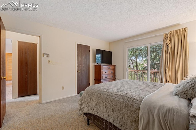 carpeted bedroom with access to outside and a textured ceiling