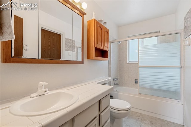 full bathroom featuring vanity, toilet, and shower / bath combination with glass door