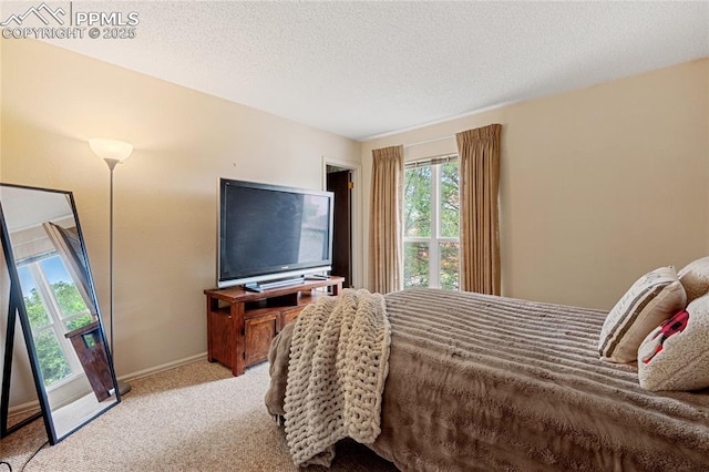 carpeted bedroom featuring a textured ceiling