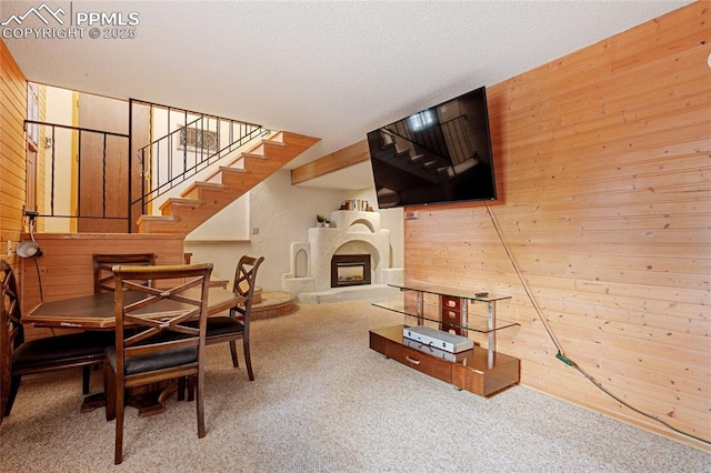 living room with wood walls and carpet floors