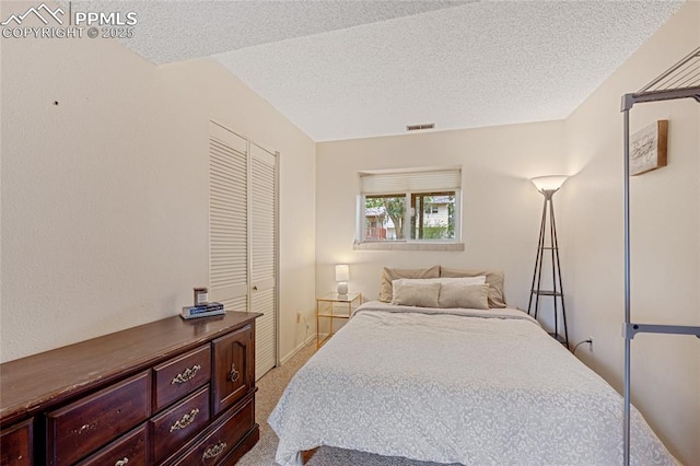 bedroom with light carpet, a closet, and a textured ceiling