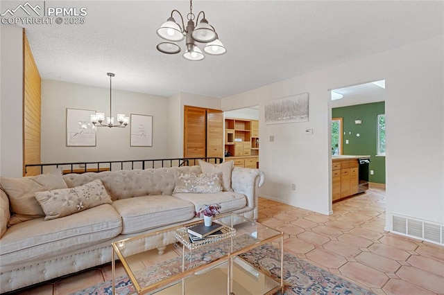 living room with a textured ceiling and a notable chandelier