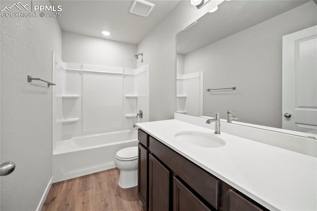 full bathroom with shower / tub combination, hardwood / wood-style floors, vanity, and toilet