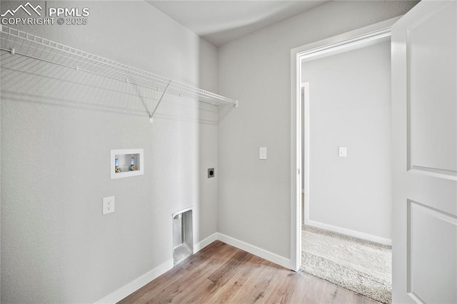 washroom with washer hookup, light hardwood / wood-style floors, and electric dryer hookup