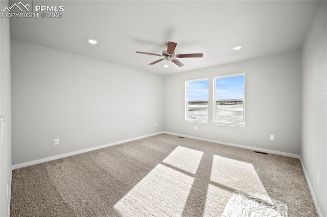 carpeted empty room featuring ceiling fan