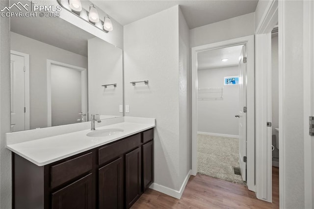 bathroom featuring vanity and hardwood / wood-style flooring