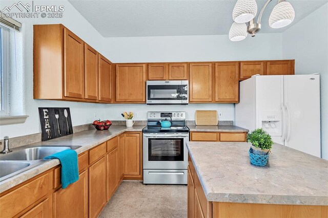 kitchen featuring stainless steel appliances, a wealth of natural light, and hanging light fixtures