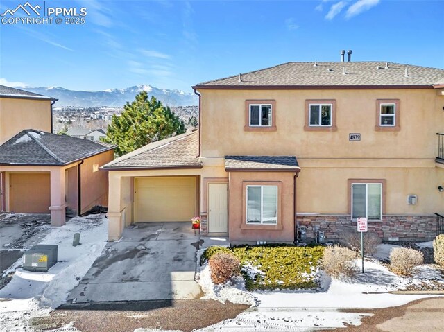 view of front of property featuring a garage and a mountain view